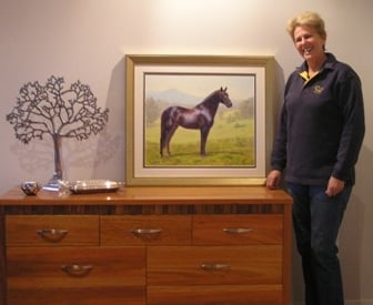 A lady with her portrait of a warmblood horse