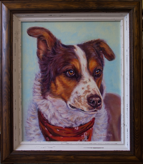 A custom framed pet portrait of a dog